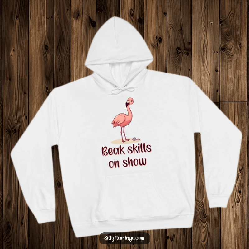 Funny Flamingo Hoodie: A happy flamingo using its beak to playfully toss a pebble, conveying cheerful vibes and lighthearted fun in a cozy design.