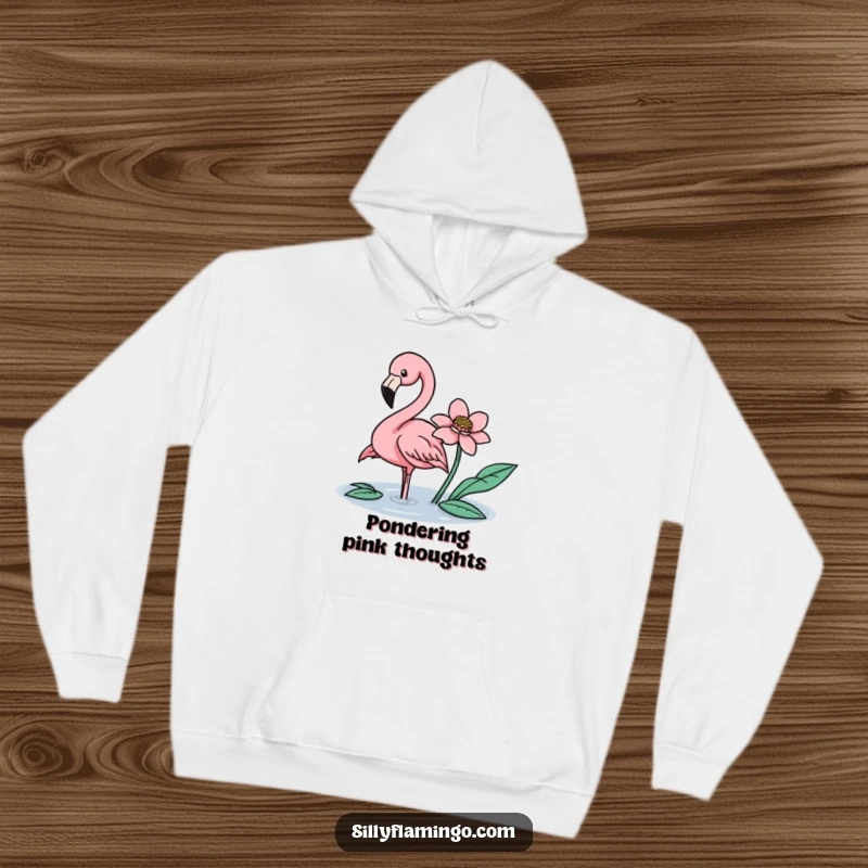 Funny flamingo gently nudging a floating flower with its beak on a warm, cozy hoodie.