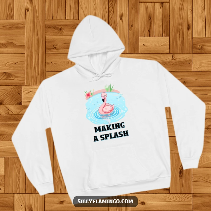 Funny flamingo hoodie showcasing a pink bird joyfully splashing in a sparkling blue pond, radiating happiness and tropical vibes.