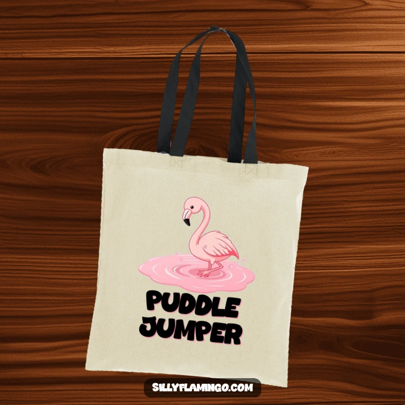 Funny flamingo tote bag depicting a bird gleefully splashing in a bright pink puddle, perfect for errands.
