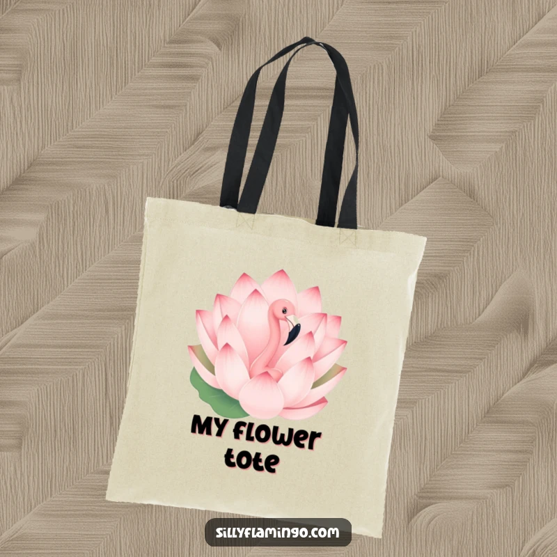 Funny tote bag with a playful flamingo peeking out from behind a giant blooming lotus flower, practical and whimsical.